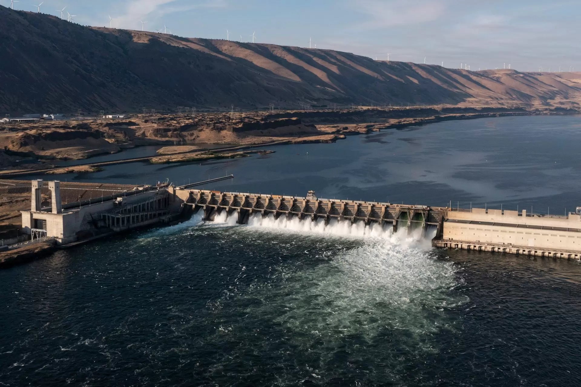 Hydroelectric dam spillway with water cascading over the structure.